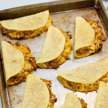 Feature image of the finished Baked Chicken Tacos on a sheet pan.