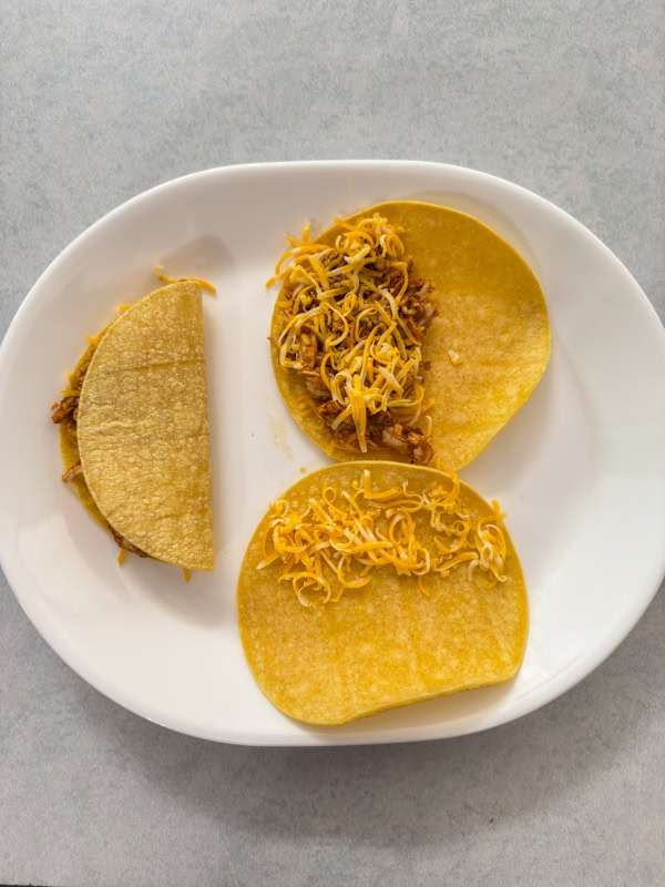 The three stages of a taco being made, the cheese, the cheese and meat and it topped with more cheese and folded over.