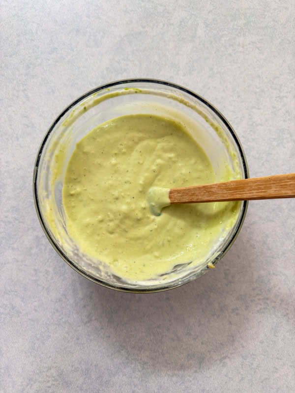 All of the ingredients for the avocado lime ranch dipping sauce combined in a small bowl.