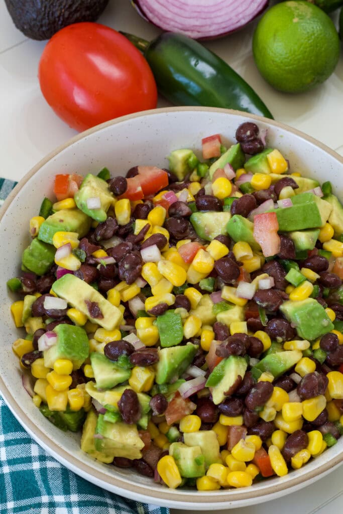 The entire batch of Black Bean and Corn Salad with Avocado in a serving bowl.