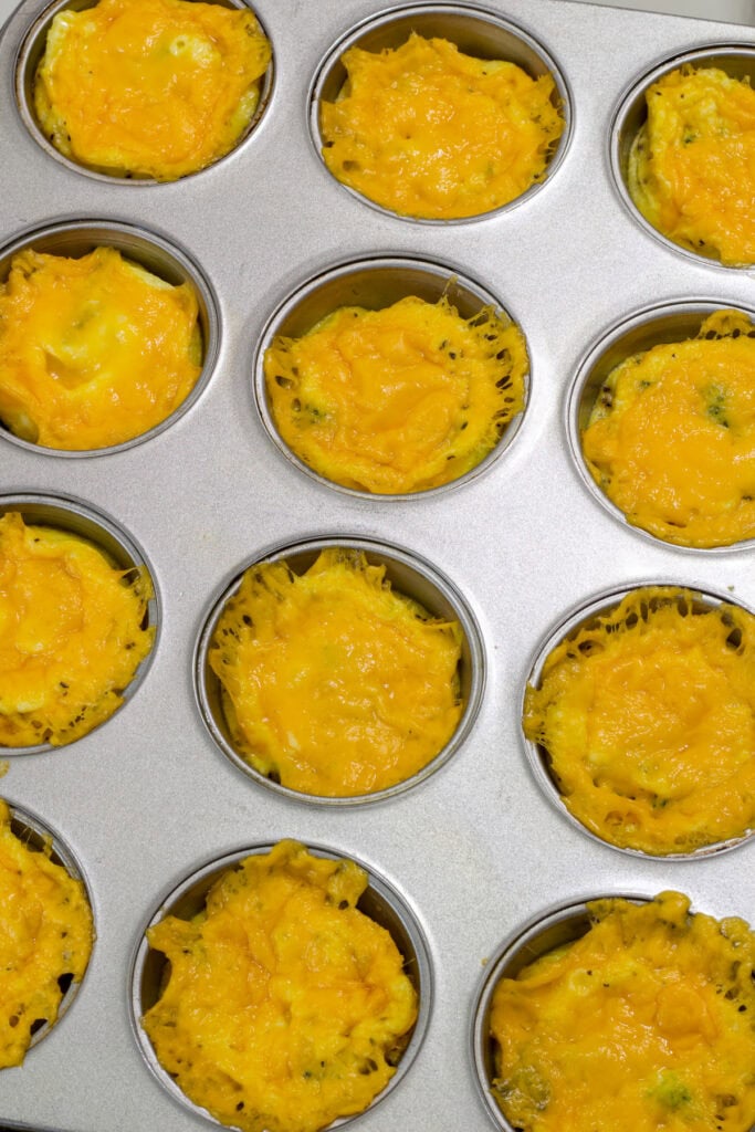 The 12-cup muffin tin with the baked Broccoli Cheddar Egg muffins in it.