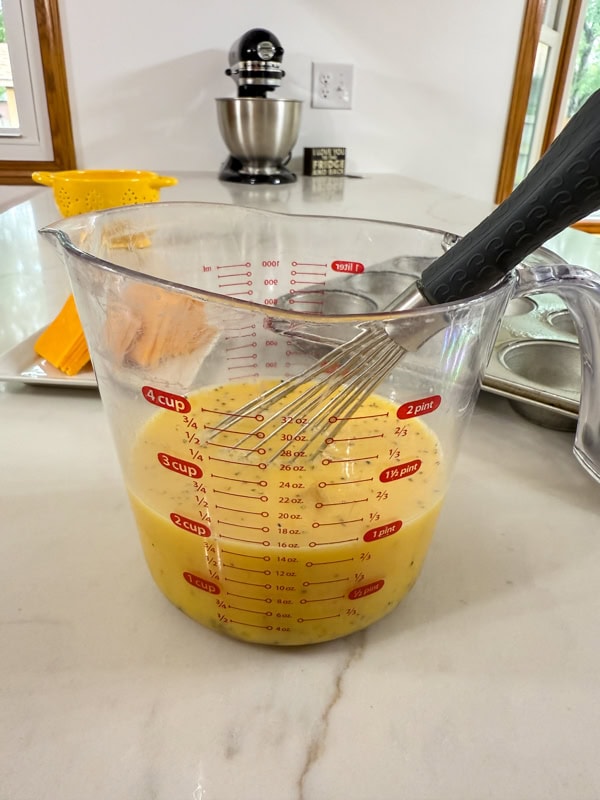 The eggs, milk, salt and pepper whisked together in a large measuring cup.