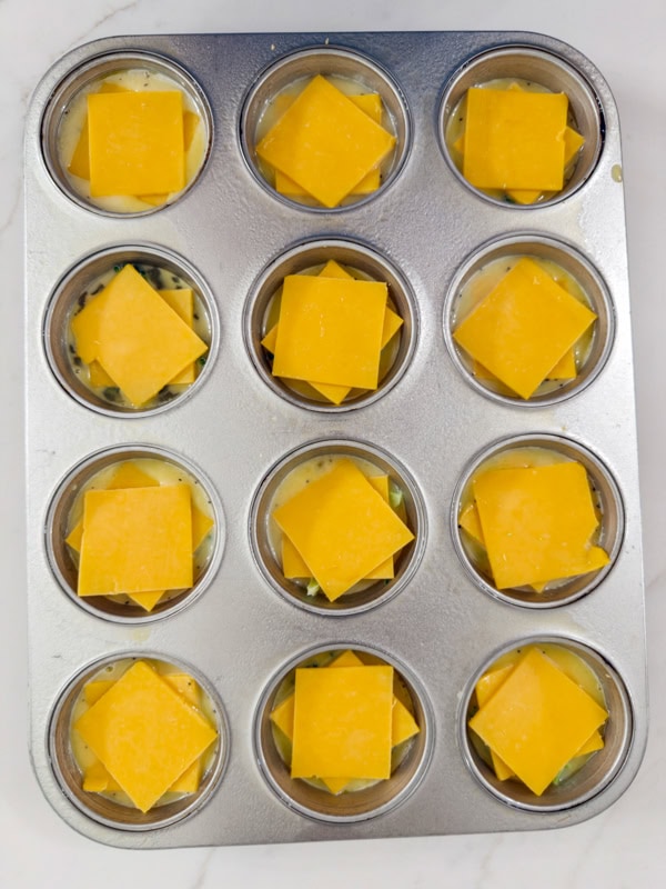 The two pieces of cheese added on top of the egg and broccoli, ready to go into the oven.