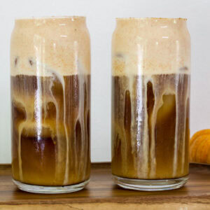 Side view of two glasses of my homemade pumpkin cold brew coffee.