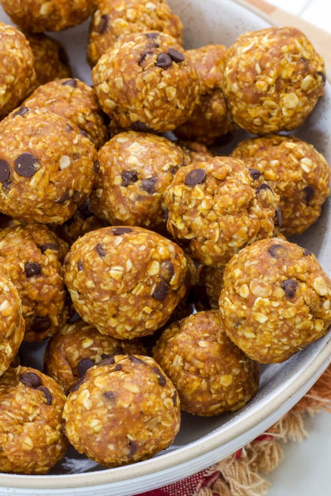 Overhead view of half of a bowl of Pumpkin Energy Balls (vegan, gluten-free).