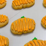 Feature image of several Pumpkin Spice Cutout Cookies that are ready to eat.