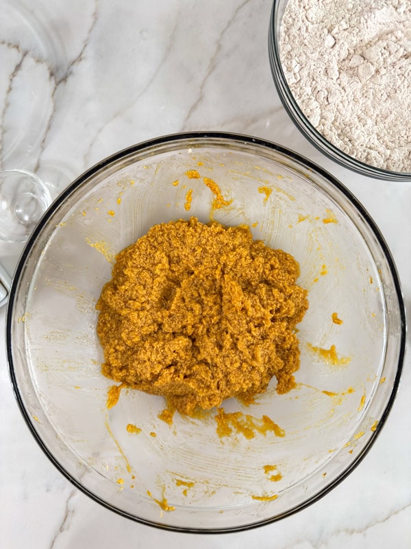 The pumpkin, butter, egg, and sugars mixed together in a large bowl.