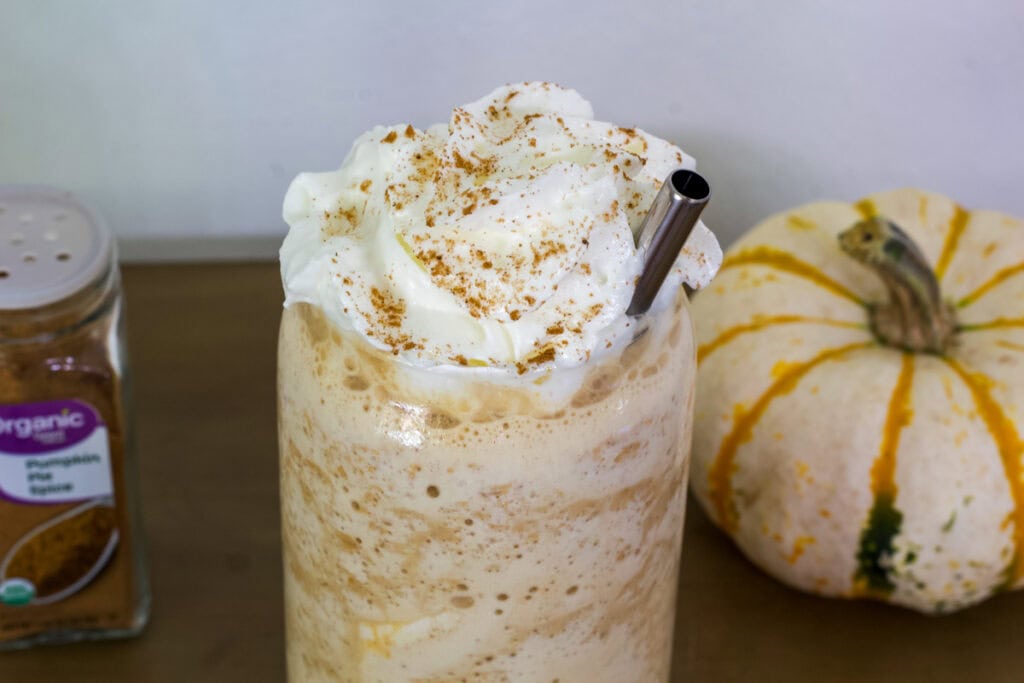 Just the top of one serving of Starbucks Pumpkin Spice Frappuccino in a glass.