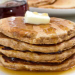 Feature image of a close up side view of the stack of four Healthy Sweet Potato Pancakes.