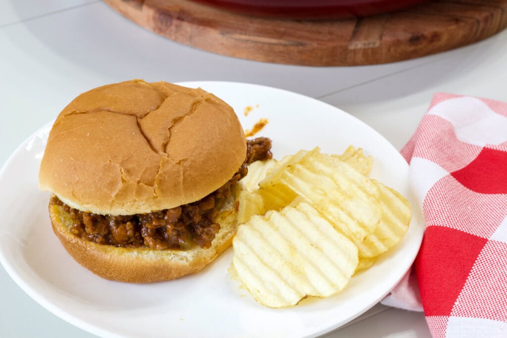 One Old Fashioned Homemade Sloppy Joes on a plate with some potato chips.