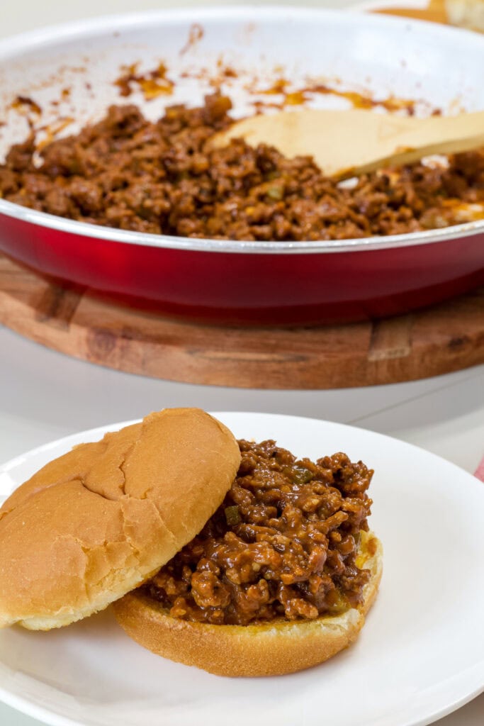One sloppy joe with the top buns sideways so the inside is visible.