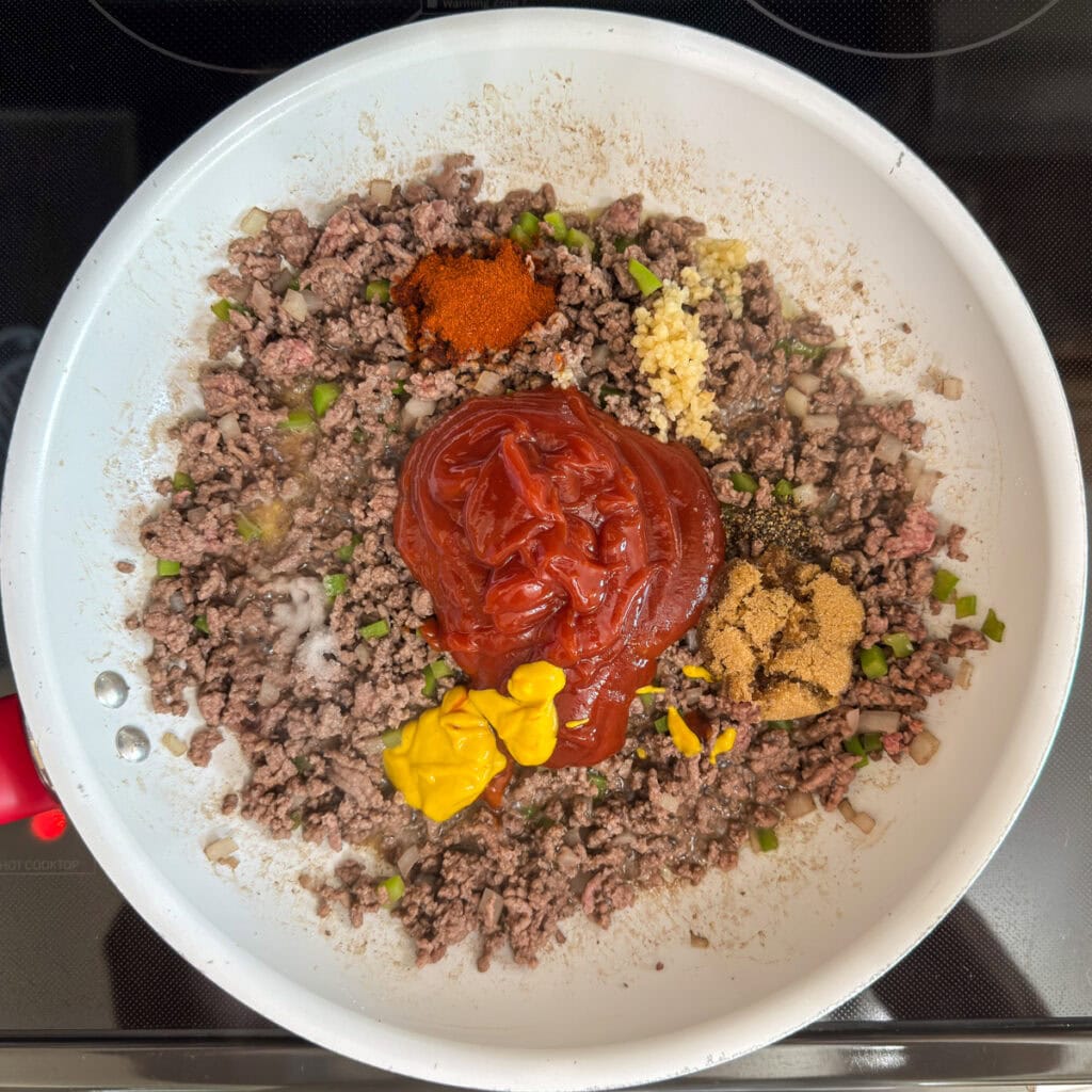 The ketchup, mustard and other ingredients added to the beef.