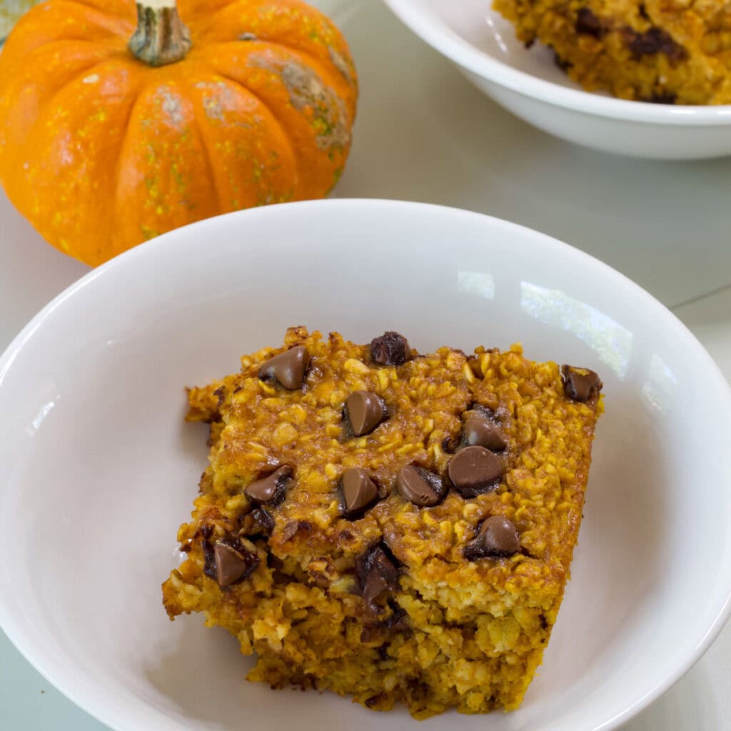 One serving of Pumpkin Chocolate Chip Baked Oatmeal in a white bowl.