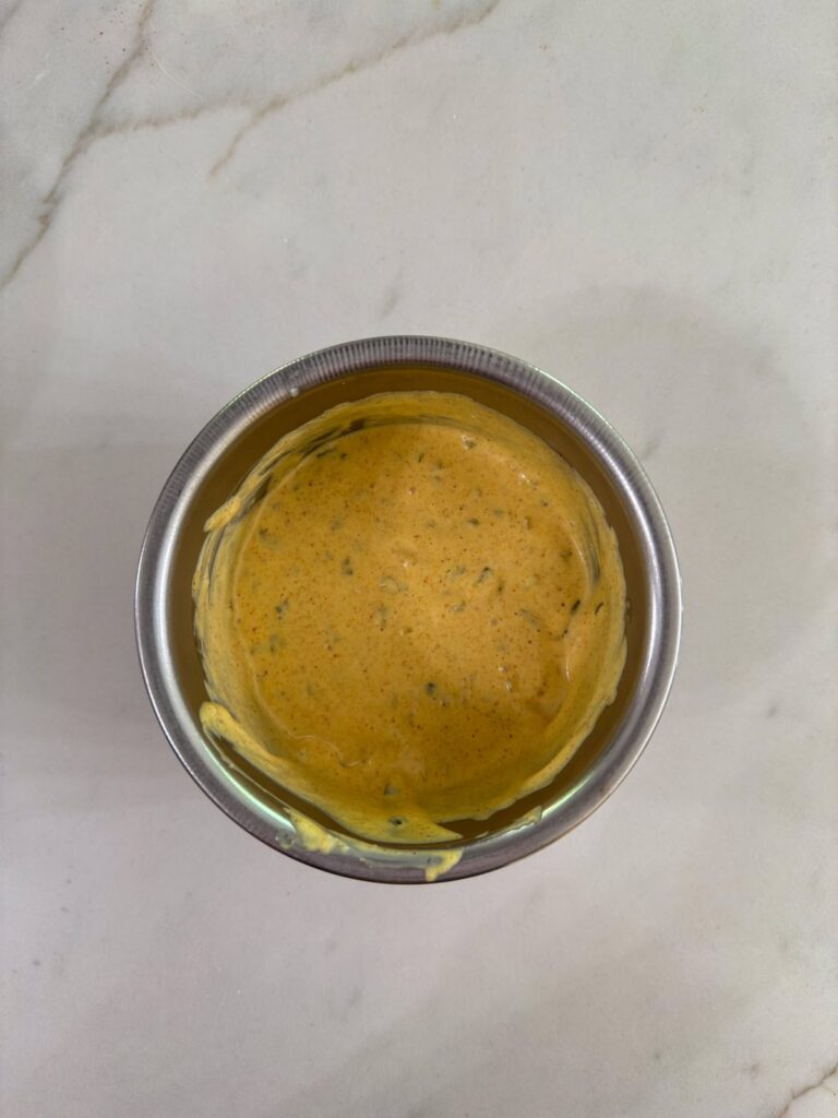 The finished homemade secret sauce in a small metal bowl.