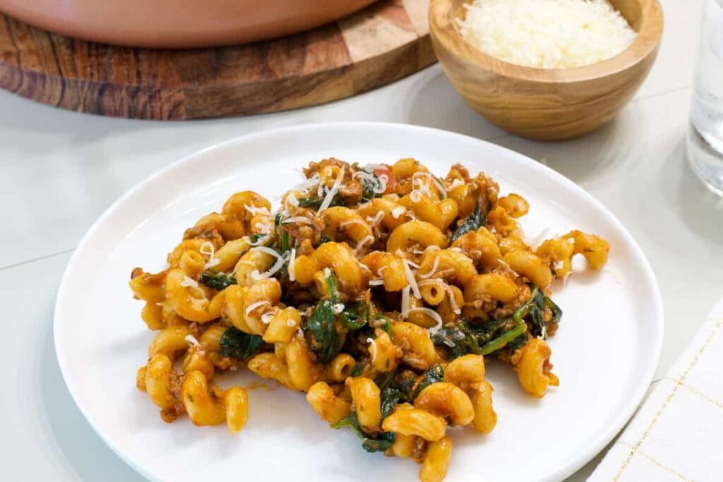 One serving of Ground Beef Spinach Pasta on a white plate.