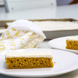 Close up side view of one piece of Healthy Pumpkin Cake so the crumb and layer of frosting are visible.
