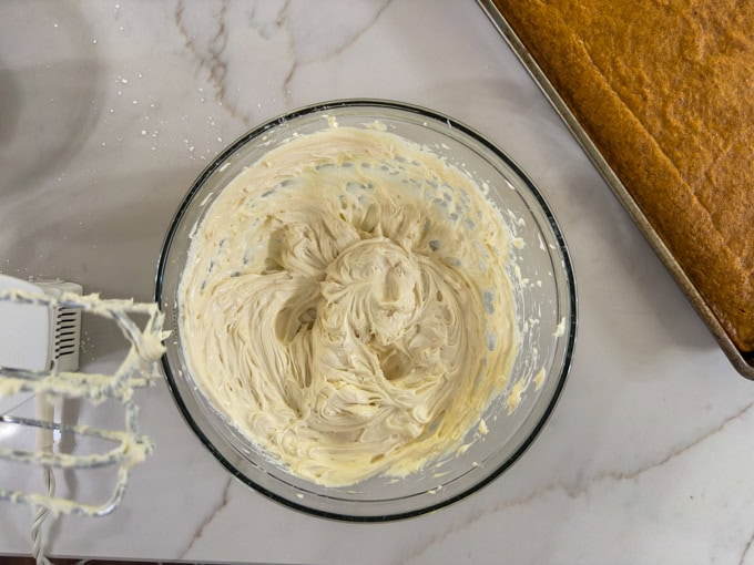The 3 ingredient healthy cream cheese frosting after it's been whipped in a medium bowl.