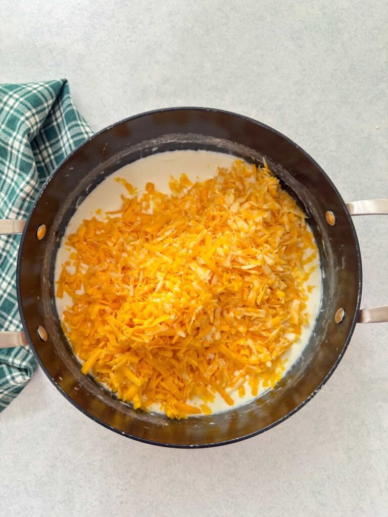 The grated cheese added to the butter, flour, and milk mixture.
