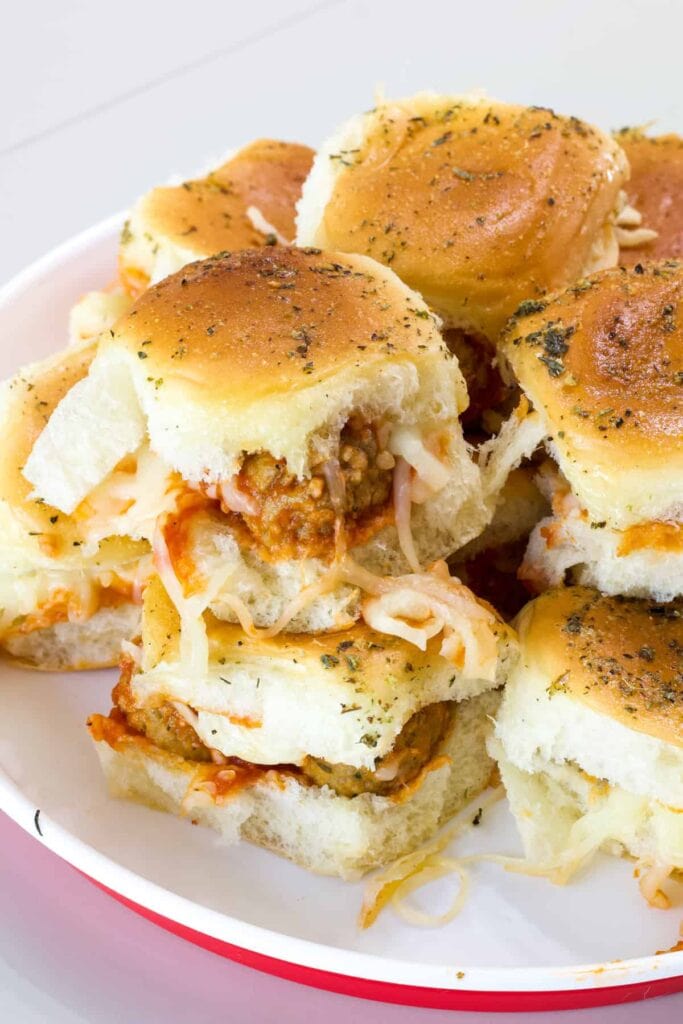 Twelve Meatball Sliders with Hawaiian Rolls on a serving plate.