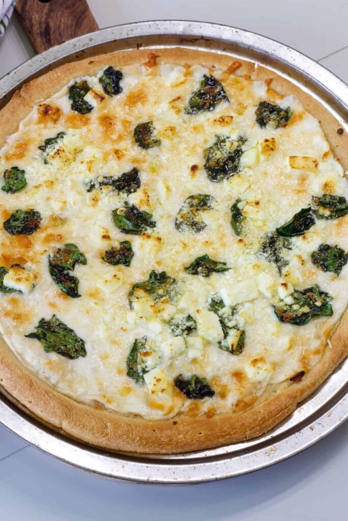 The entire uncut baked Spinach and Feta Pizza.
