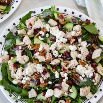 Overhead shot of one Green Salad with Chicken on a plate ready to be eaten.