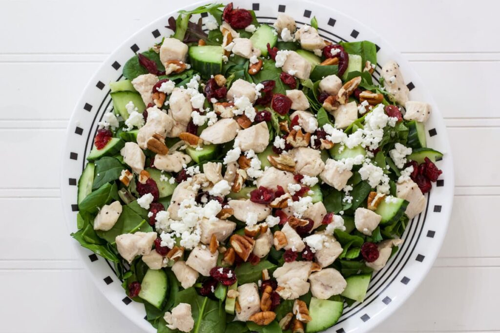 The dried cranberries, feta cheese and chopped pecans added to the salad.
