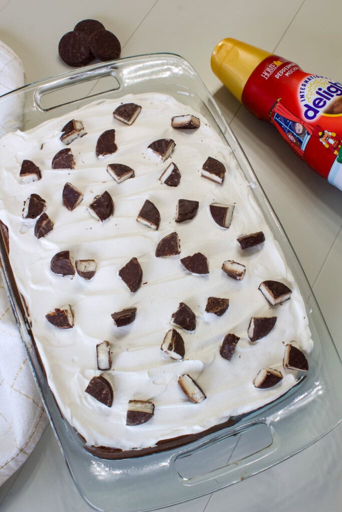 The entire uncut Peppermint Mocha Poke Cake in a glass baking dish.