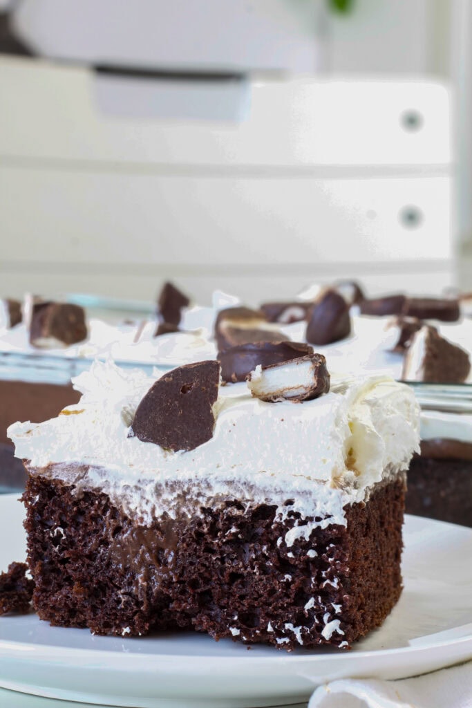 Side view of one piece of Peppermint Mocha Poke Cake on a plate.