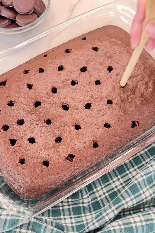 The baked caked with holes poked in it with a wooden spoon.