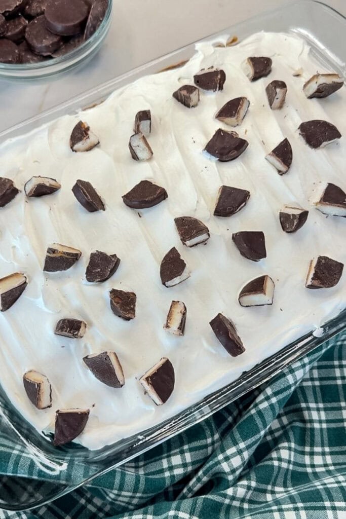 The cake topped with chopped peppermint patties.