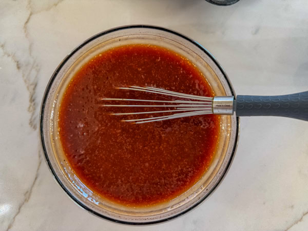 The cola, barbecue sauce and ketchup combined in a small bowl.