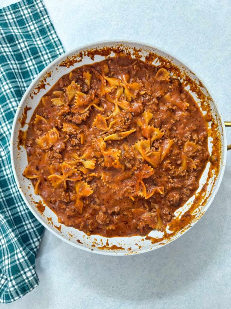 The dish after the bowtie pasta has been added, before it was topped with cheese.