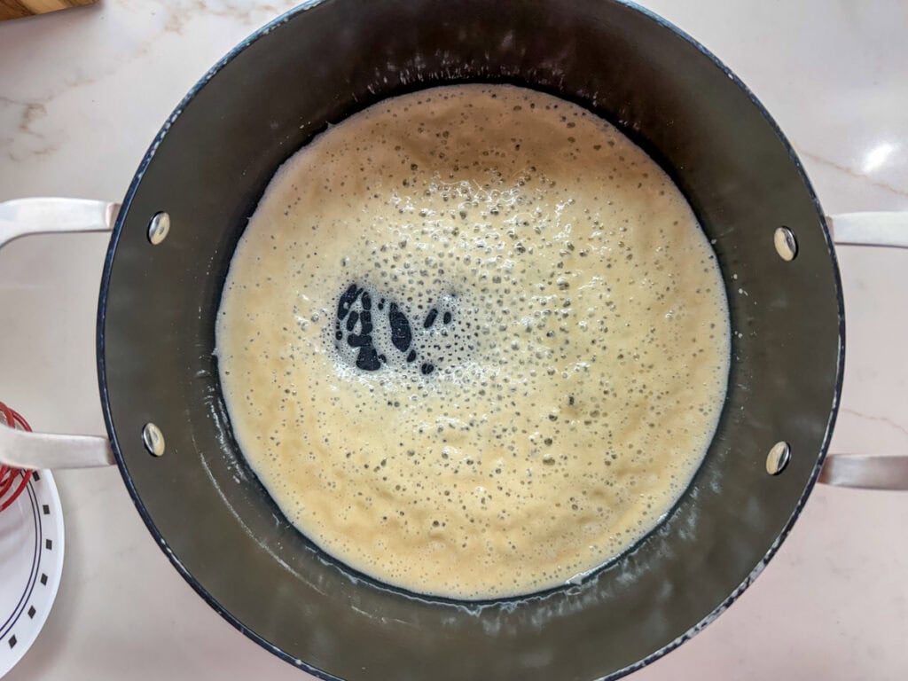 The canola oil and flour in the Dutch oven after it's been heated and is bubbly.