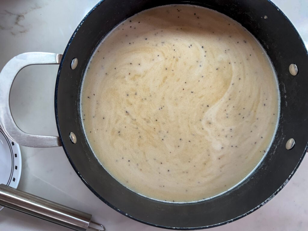 The beef broth added to the pot with the flour mixture.