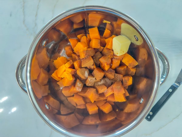 The diced sweet potatoes in the pan after they've been steamed and the other ingredients have been added.