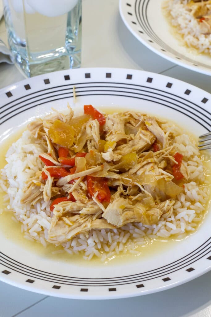 One serving of Slow Cooker Peach Chicken on a bed of white rice.