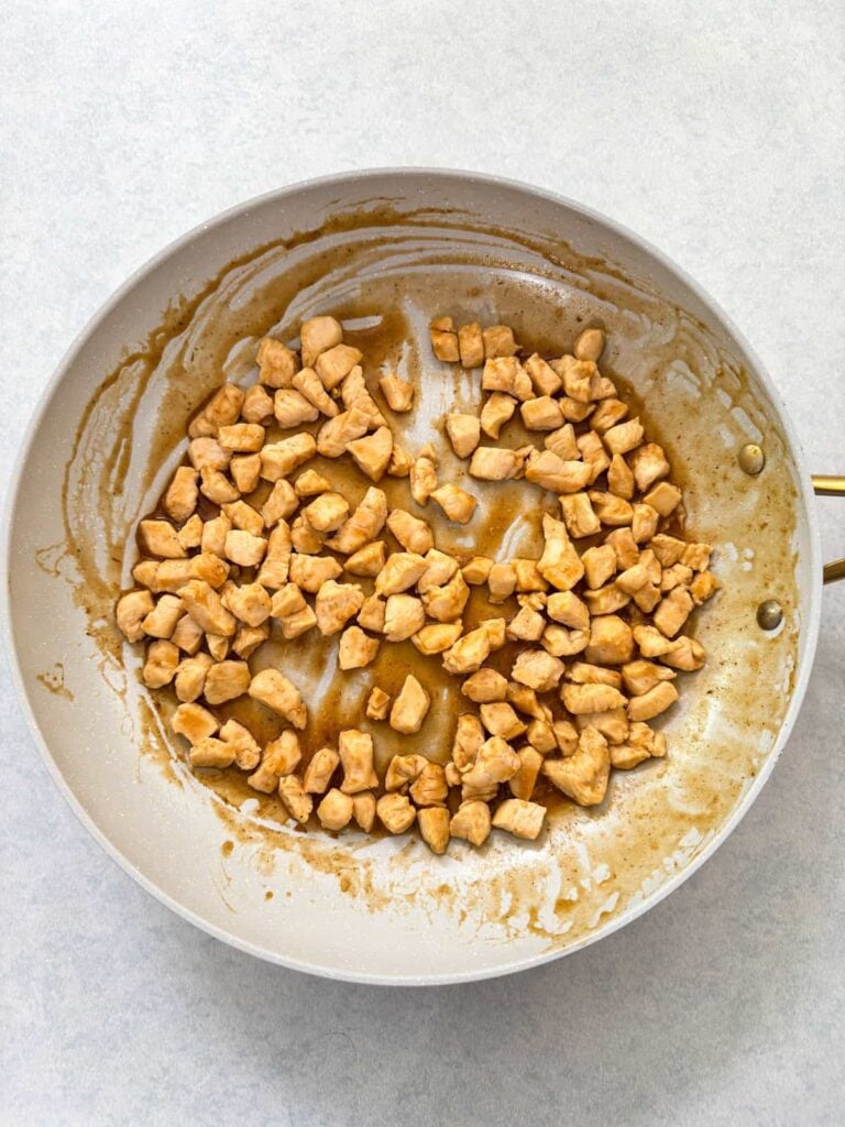 The cooked chicken with the barbecue sauce mixed in.