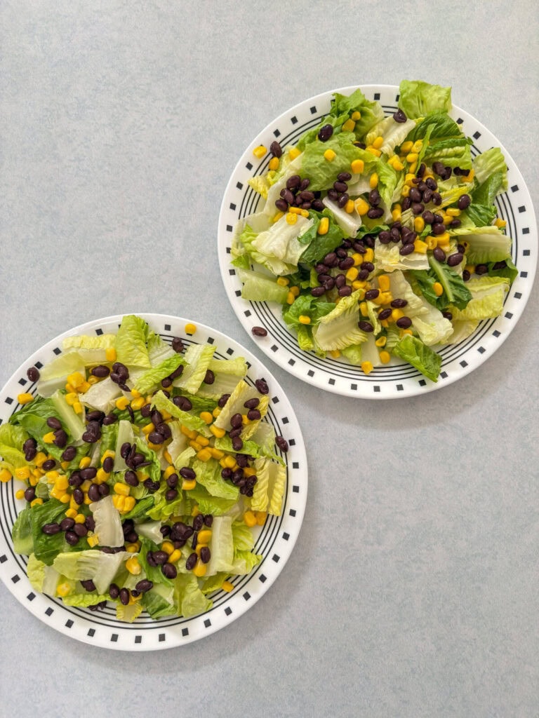 The romaine lettuce corn and black beans spread out on two plates.