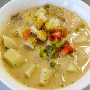 Overhead close up of one bowl of soup that's not garnished.