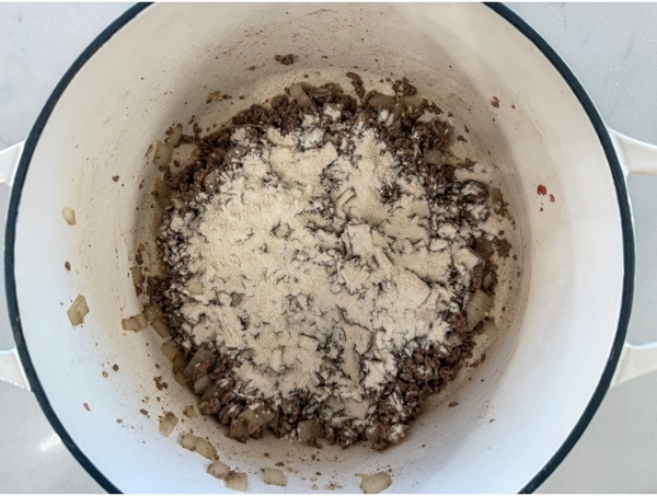 The flour sprinkled over the ground beef.