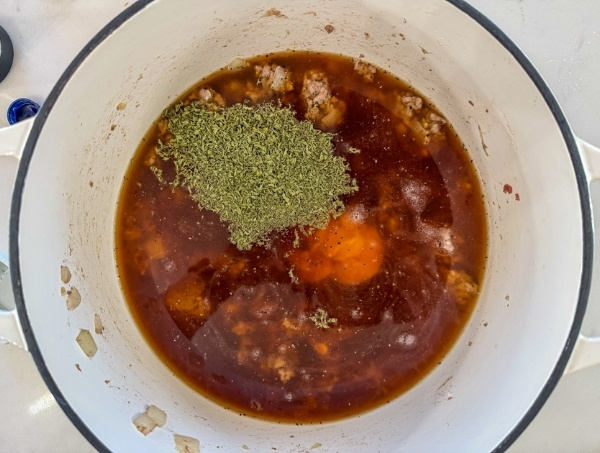 The broth and spices added to the pot.