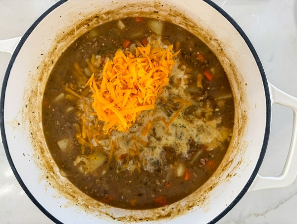 The cheese and milk added to the pot.