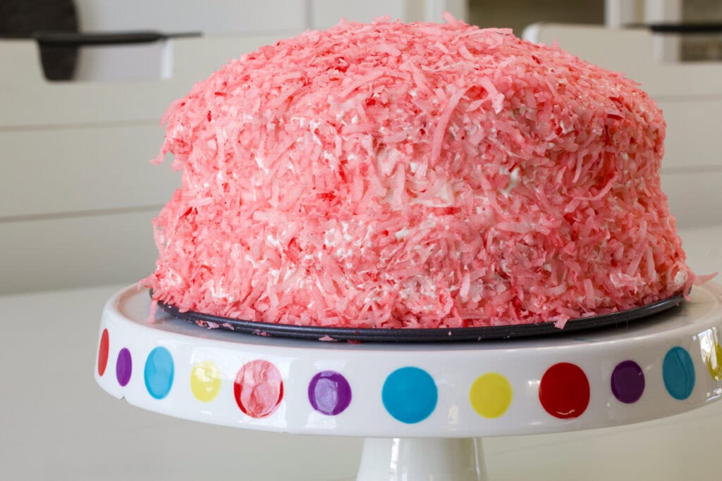 Side shot of the Easy Hostess Inspired Snoball Cake on a cake stand.