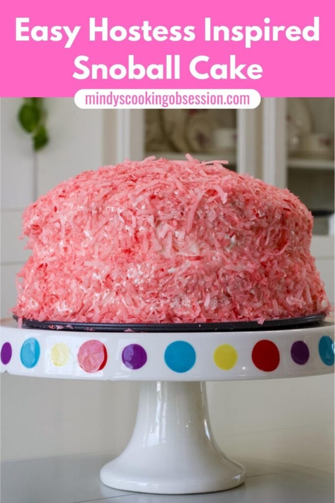The finished cake on a cake stand with the recipe title in text at the top.