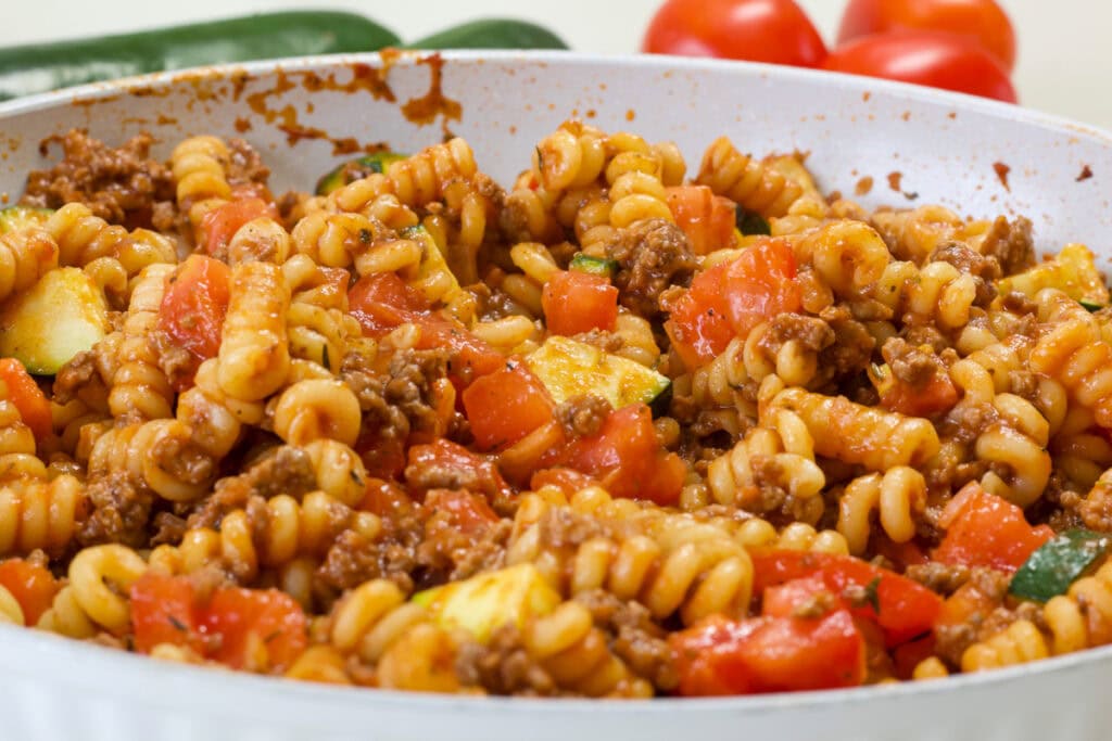 The entire batch of Pasta with Zucchini and Tomatoes in a skillet.