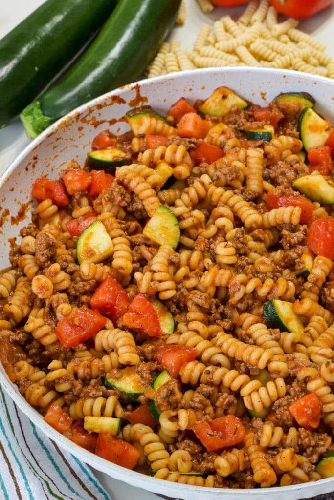 Overhead close up of the Pasta with Zucchini and Tomatoes in a pan.
