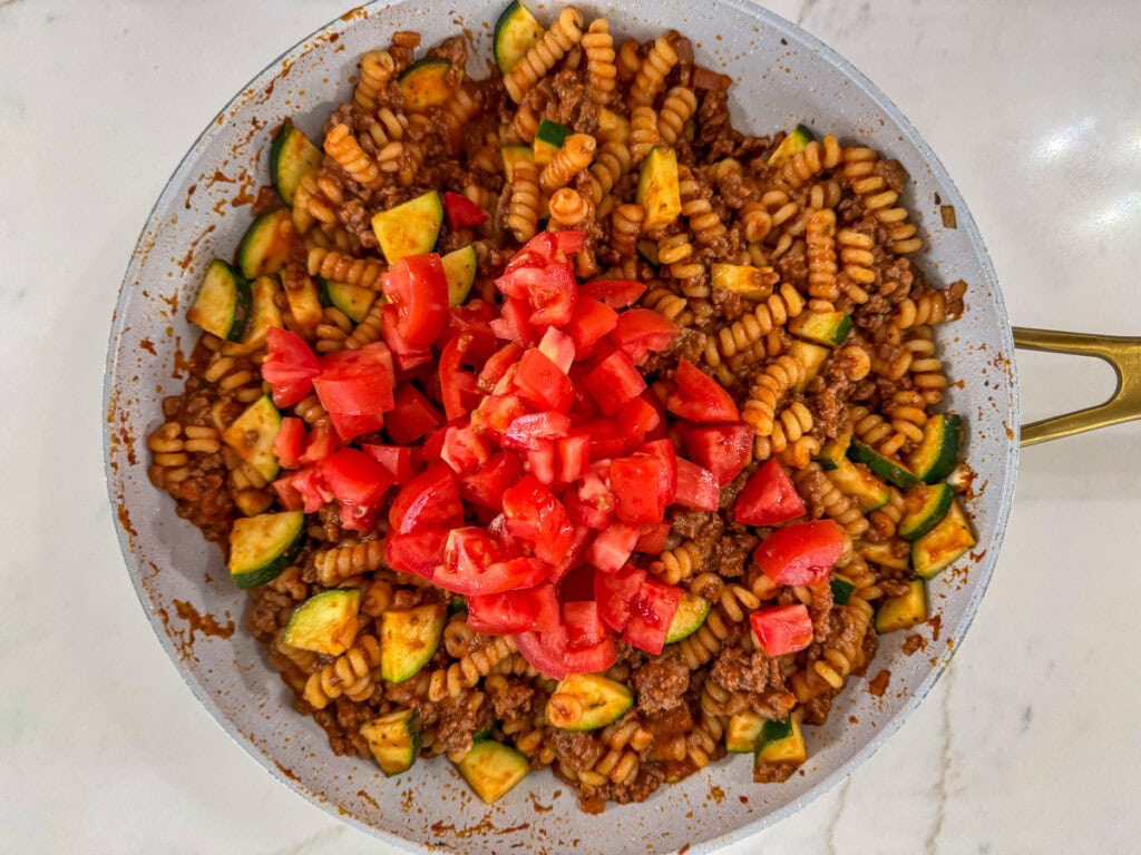The chopped tomatoes added to the skillet.