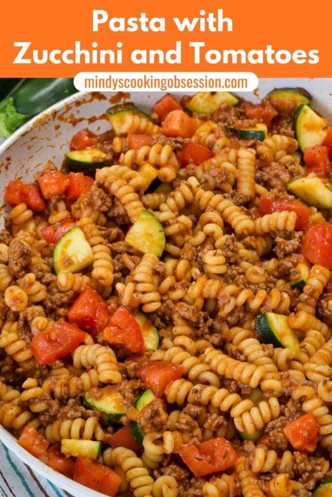 Close up of the Pasta with Zucchini and Tomatoes in a skillet with the recipe title at the top in text.