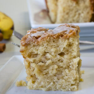Close-up of a single serving of banana sour cream coffee cake with moist interior visible.