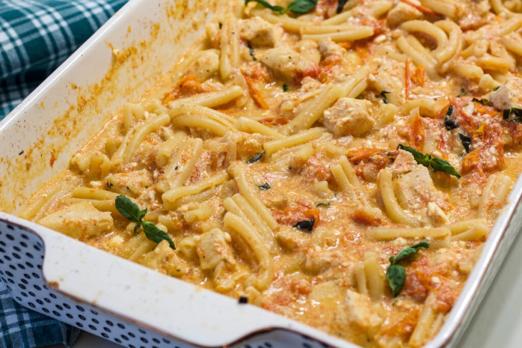 The entire batch of Easy Baked Feta Pasta with Chicken in a casserole dish.
